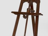 a wooden easel with a wooden stand on it