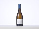 a bottle of white wine sitting on top of a table