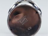 an image of a silver plate with a silver ring on top of it