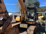 a picture of a large excavator that is sitting in the dirt