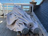 a table with a cloth on it sitting on a deck