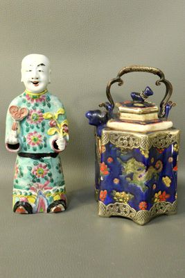 two figurines of a man and a woman standing next to each other