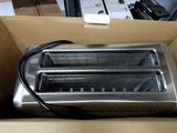 a toaster that is in a box on the floor