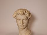 a close up of a statue of a man ' s head on a table