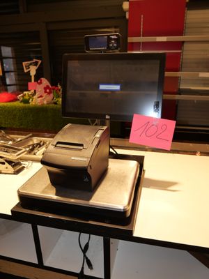 a printer sitting on top of a desk next to a monitor