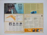 two pages of the beatles ' s album are open on a table