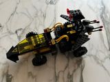 a black and yellow lego vehicle on a marble surface
