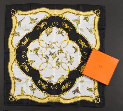 a black and white scarf with a gold border and a orange box