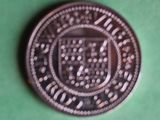 a silver coin with a picture of a coat of arms on it