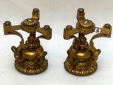 pair of antique brass candlesticks on a white background