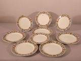 six plates with floral designs are arranged on a table