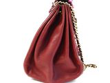 red leather purse with gold chain strap on white background