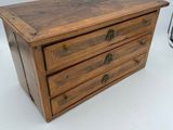 an image of a small wooden chest with three drawers