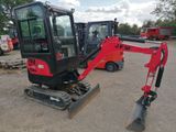 a small red excavator that is parked in a lot
