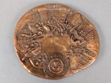 an image of a bronze medal with a picture on it