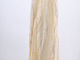 beige dress hanging on a black hanger against a white wall