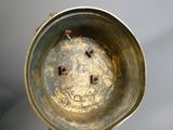 a gold vase that is sitting on a table
