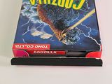 a box of godzilla on a table with a white background