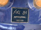 a close up of a blue motorcycle with a sign on it