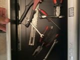 a man holding a wrench and a wrench in a cabinet