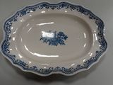 a blue and white plate with a flower design on it