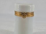 an image of a white candle with a gold band around it
