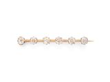une photo d'une broche en forme de lingot, en or et diamants