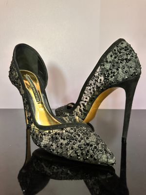 a close up of a pair of high heeled shoes on a table