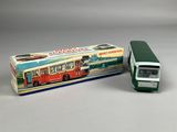a toy bus that is sitting next to a box