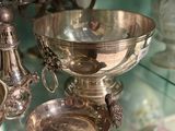 a glass display case with silver objects on it