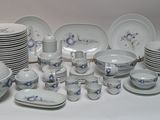 a lot of plates and bowls that are sitting on a table