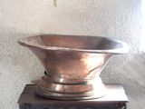 a metal bowl sitting on top of a stove