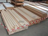 many pieces of wood stacked on top of each other in a warehouse