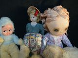 five dolls sitting next to each other on a black background