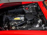 the engine compartment of a red sports car with its hood open