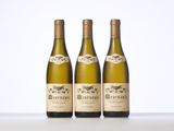 three bottles of wine sitting on top of a white table