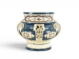 un vase bleu et blanc posé sur une surface blanche