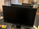 a computer monitor sitting on a desk in a home office