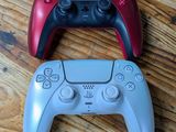 two video game controllers sitting on a wooden table