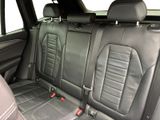 the back seats of a car with black leather and a red seat belt