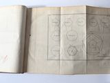 an open book with a drawing on it sitting on top of a table