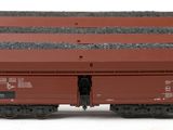 three red train cars sitting next to each other on a white surface