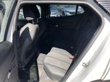 the back seat of a car with the door open in a parking lot