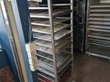 many trays of food that are sitting on a rack
