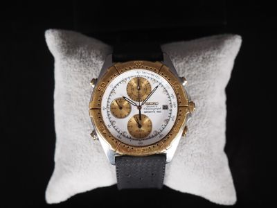 an image of a close up of a watch on a pillow