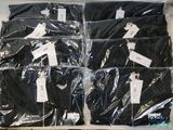 six pairs of black shirts wrapped in plastic on a table