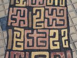 an image of a rug on a tiled floor with a pattern on it