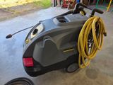 a machine that is sitting on the ground with a hose