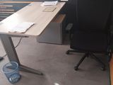 a desk with a chair in front of a window