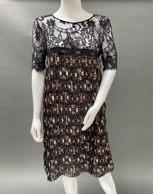 a mannequin wearing a black dress with a floral pattern